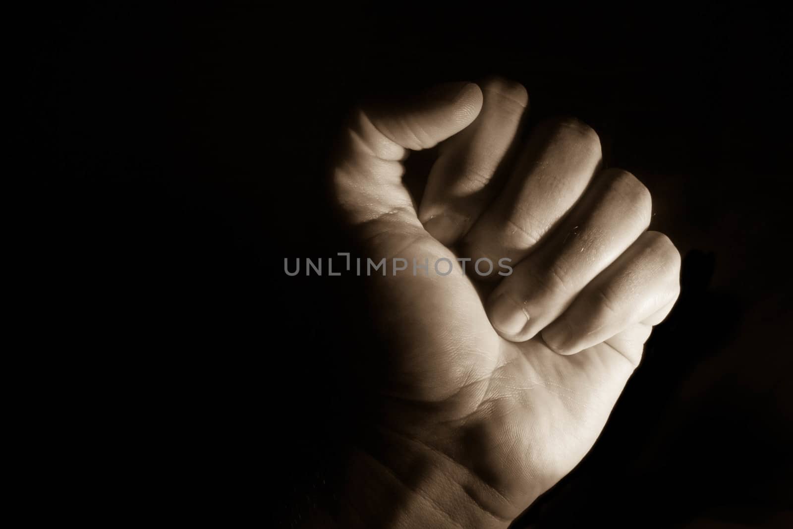 A low key shot of clenched fist.