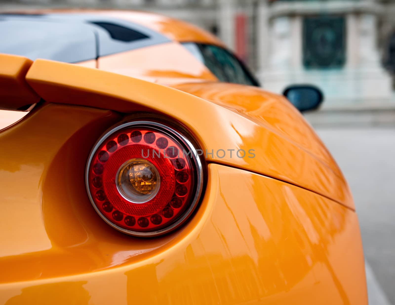 Back of an orange sports car by anderm