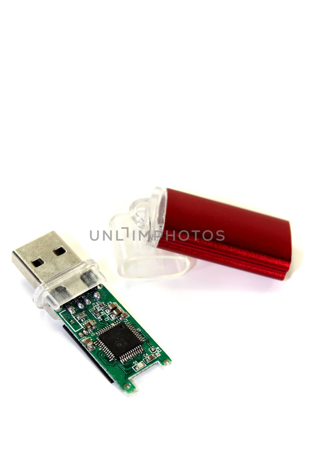 disassembled little red USB flash drive on a light background