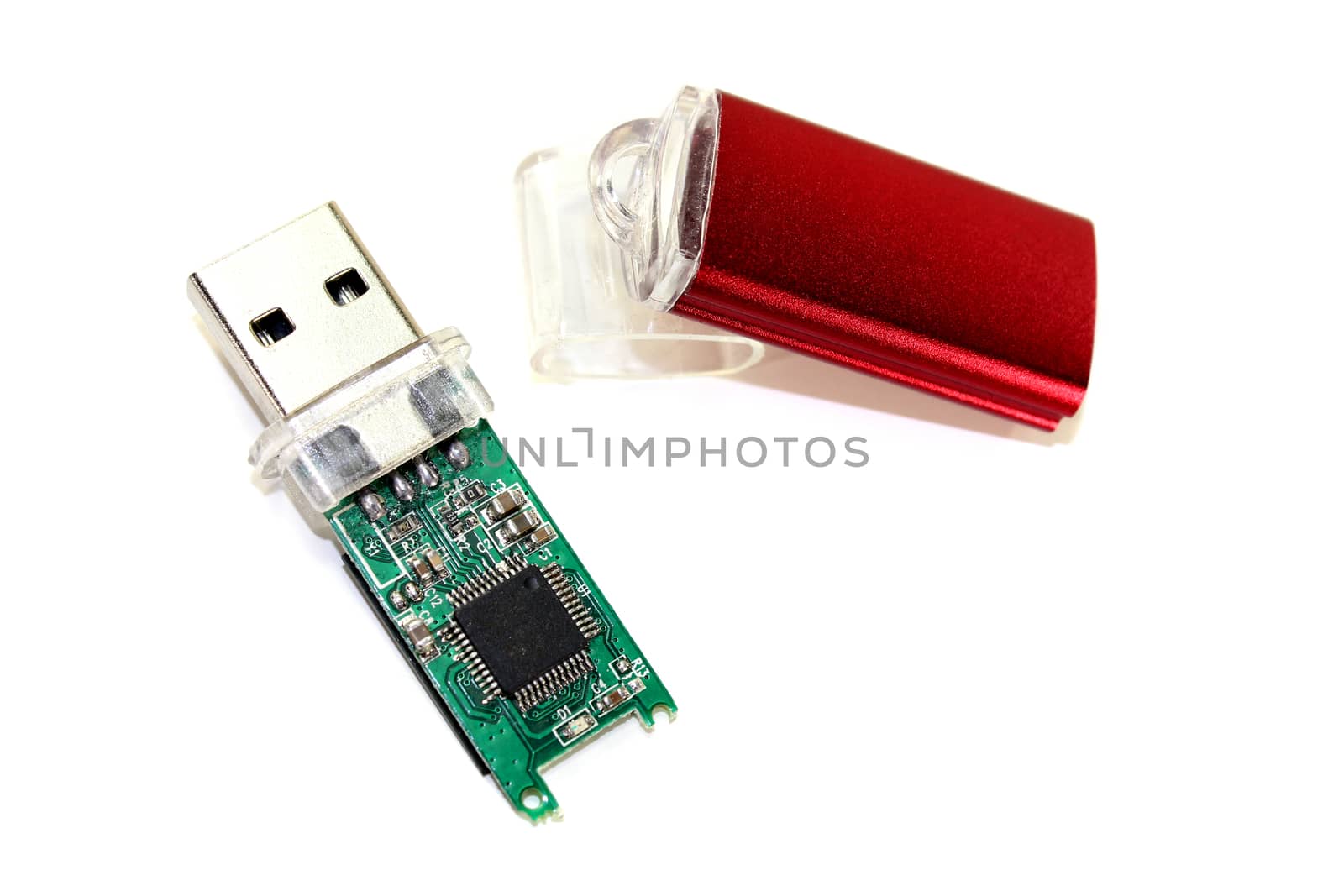 disassembled little USB flash drive on a light background