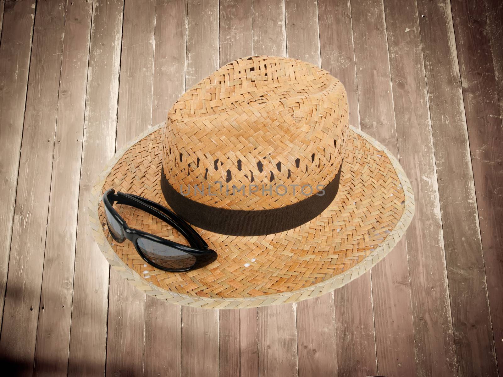 summer hat on textured wooden boards floor