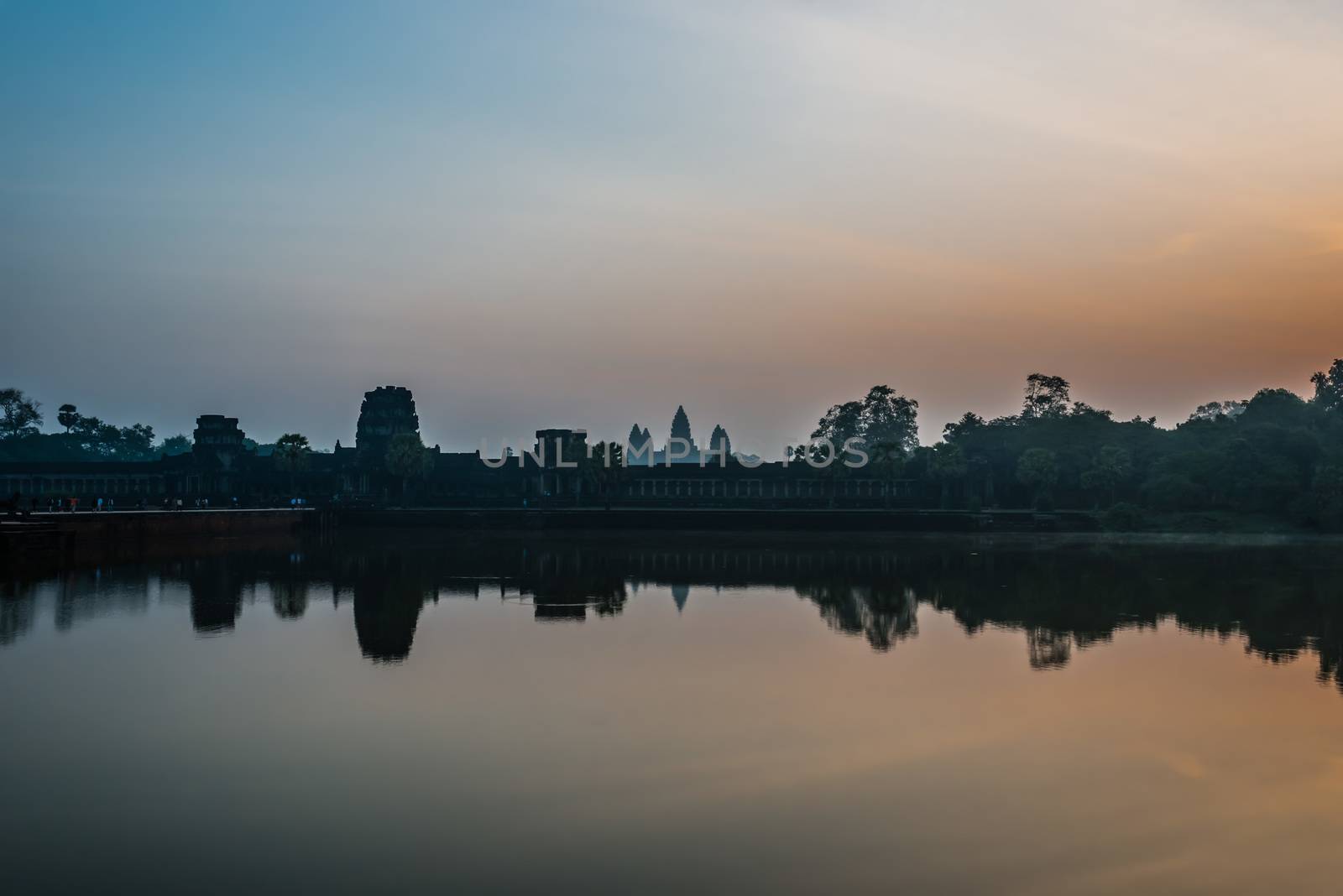 tourist entering Angkor Wat panorama across the moat Cambodia by PIXSTILL