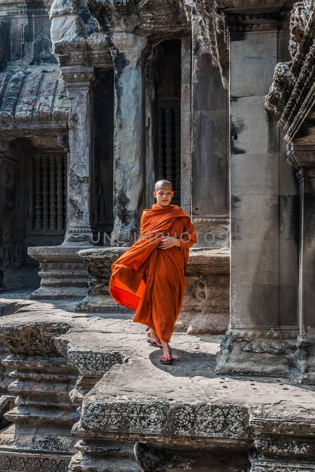 buddhist monk walking in Angkor Wat Cambodia by PIXSTILL