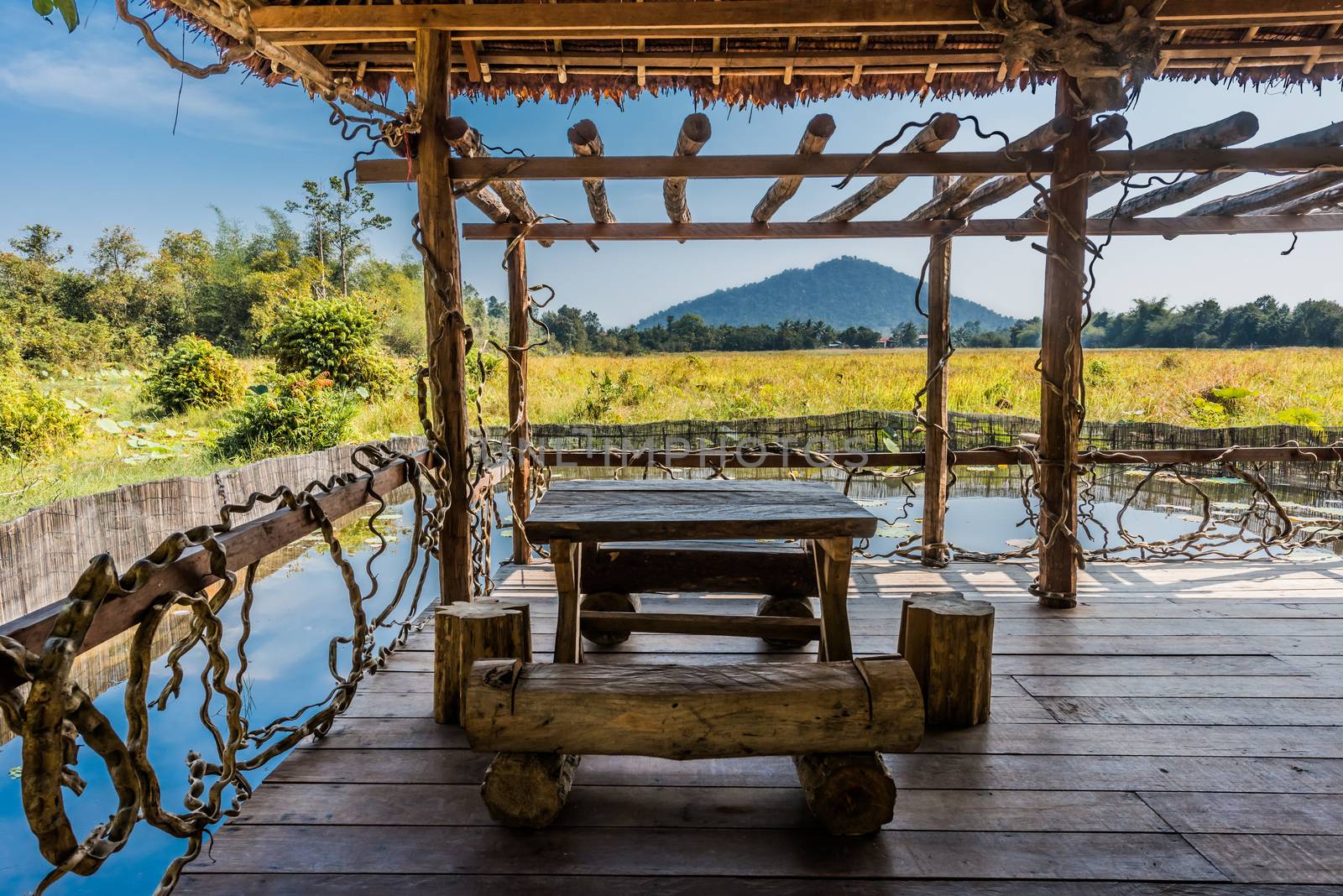 wooden table at terrace Angkor Cambodia by PIXSTILL