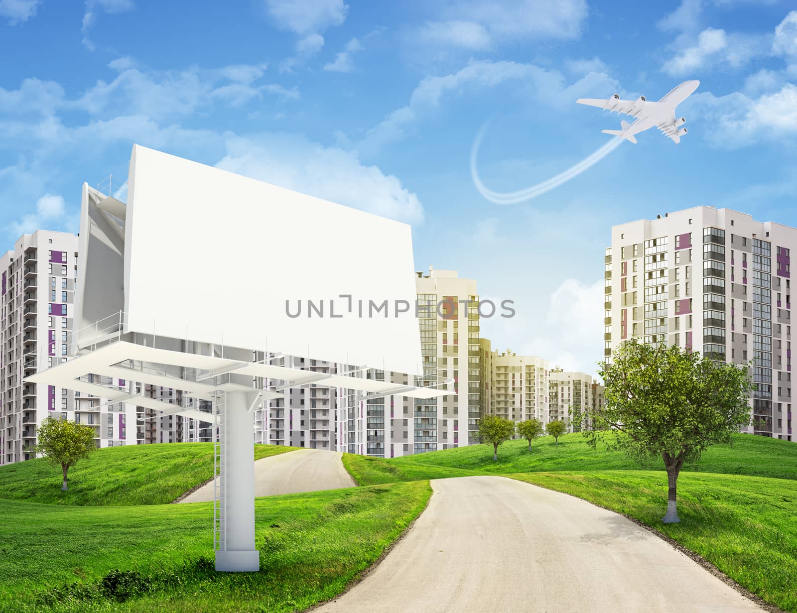 Road running through green hills with some trees, towards high-rise buildings with jet lowering above. Blank billboard with lighting on foreground.