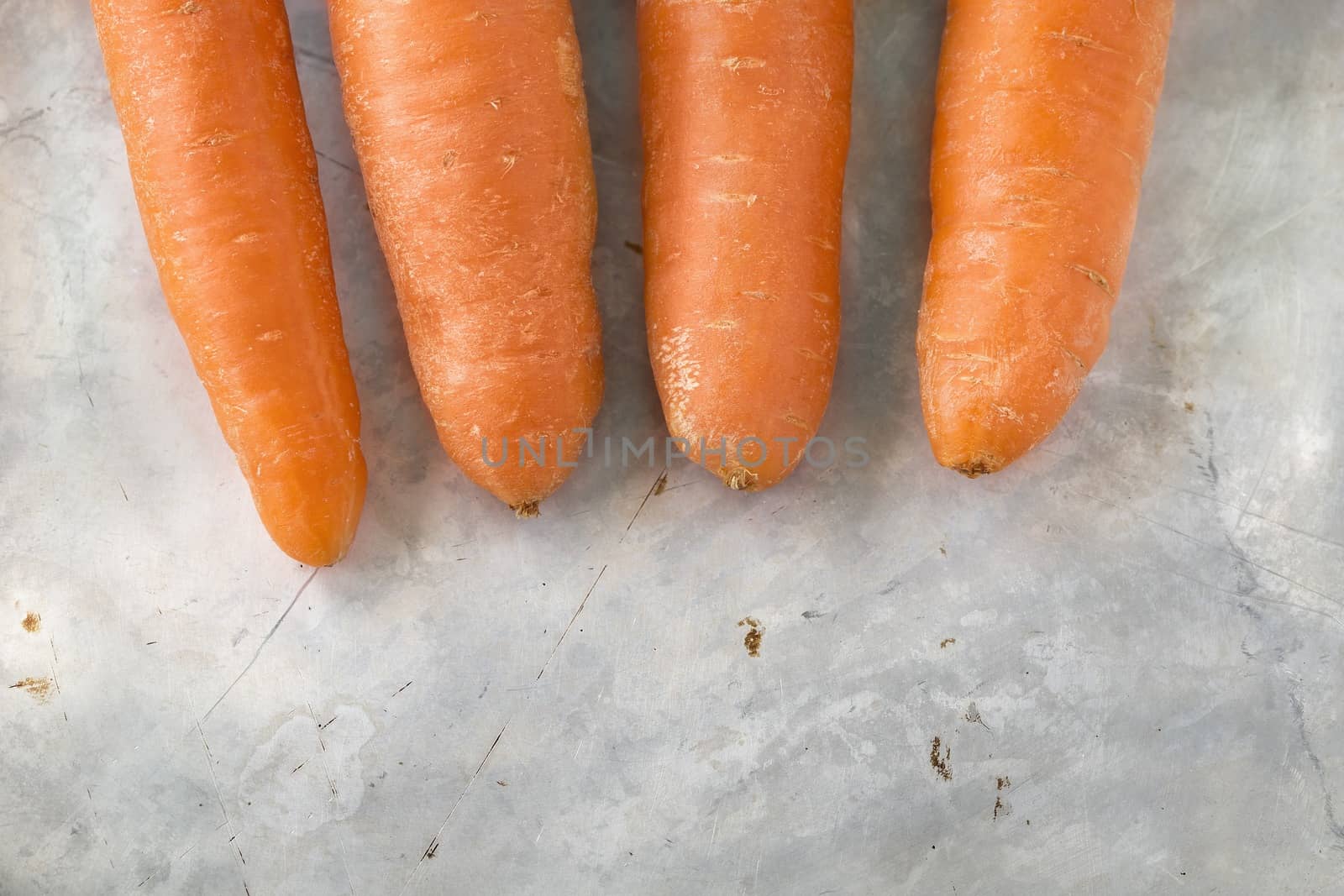 Picture of carrots on a grunge metal surface