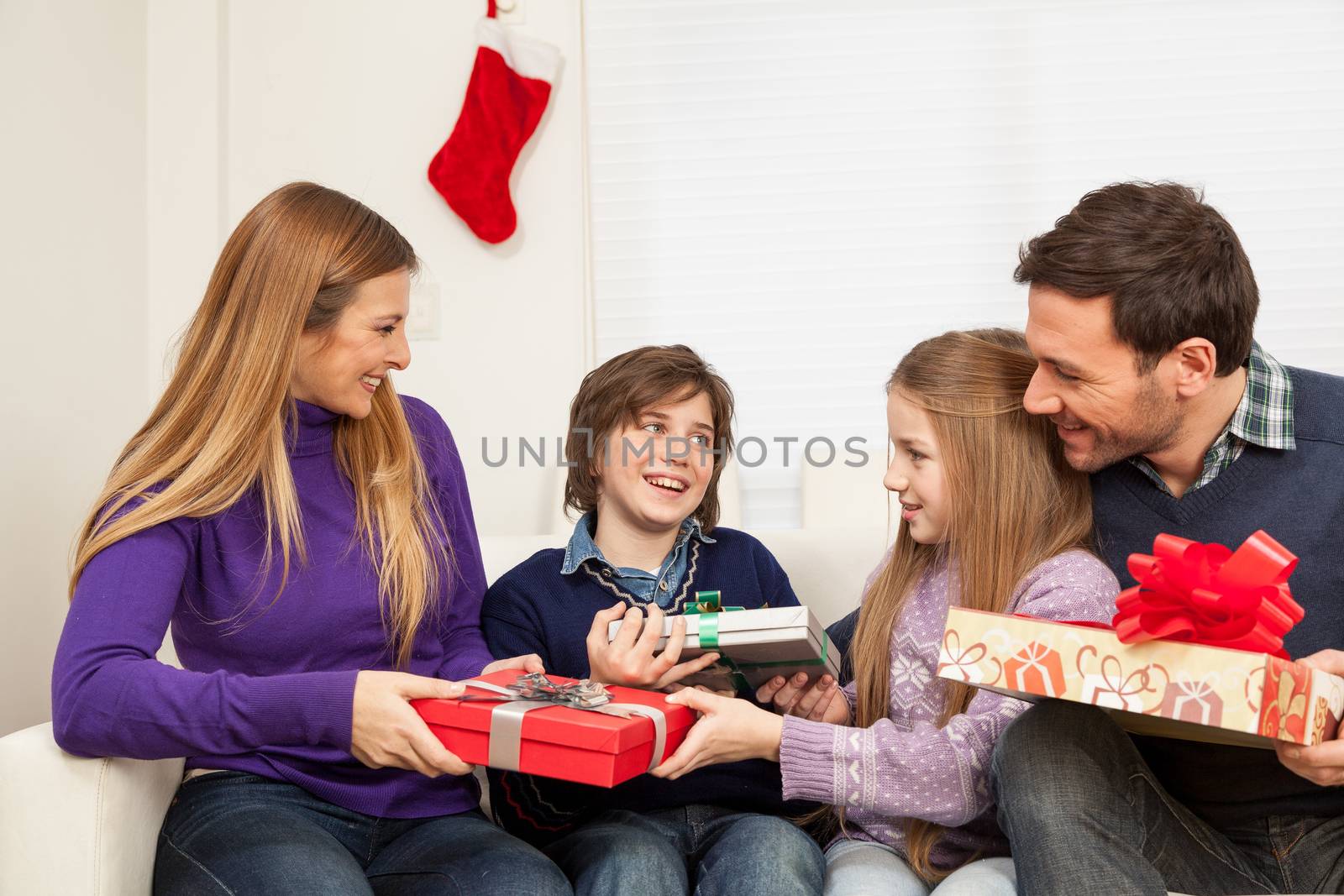 Happy family opening the christmas gift by ifilms