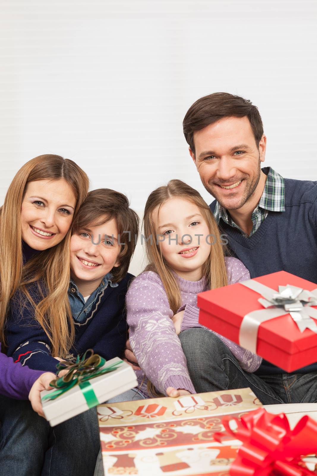 Family smiling giving presents by ifilms