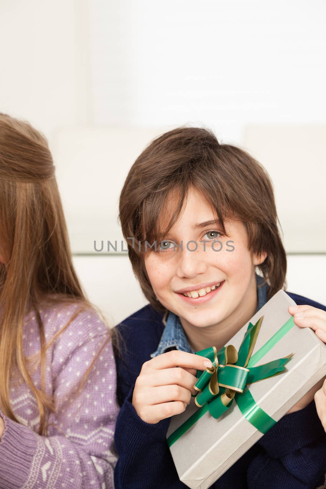 10-12, adorable, at, background, beauty, boy, camera, care, casual, caucasian, celebration, child, christmas, cute, eyes, face, front, fun, gift, giftbox, green, hand, happiness, happy, joy, kid, laughing, little, look, looking, male, portrait,  model, old, one, people, person, portrait, property, releases, ribbon, single, small, smile, son, vertical, white, years, young