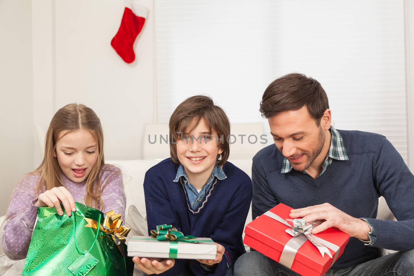 Father with his sons open his present for christmas by ifilms