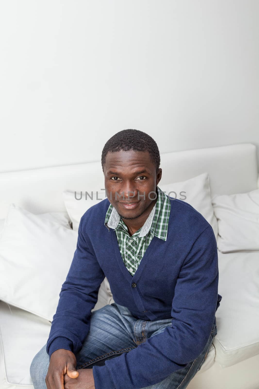 30-35, adult, african, apartment, at, attractive, black, camera, casual, christmas, cute, festive, festivity, front, happy, holidays, home, homey, house, household, inside, joyful, leisure, life, living, looking, male, man, model, old, one, person, portrait, pretty, property, releases, room, sit, sitting, smiling, sofa, sweater, time, vertical, years