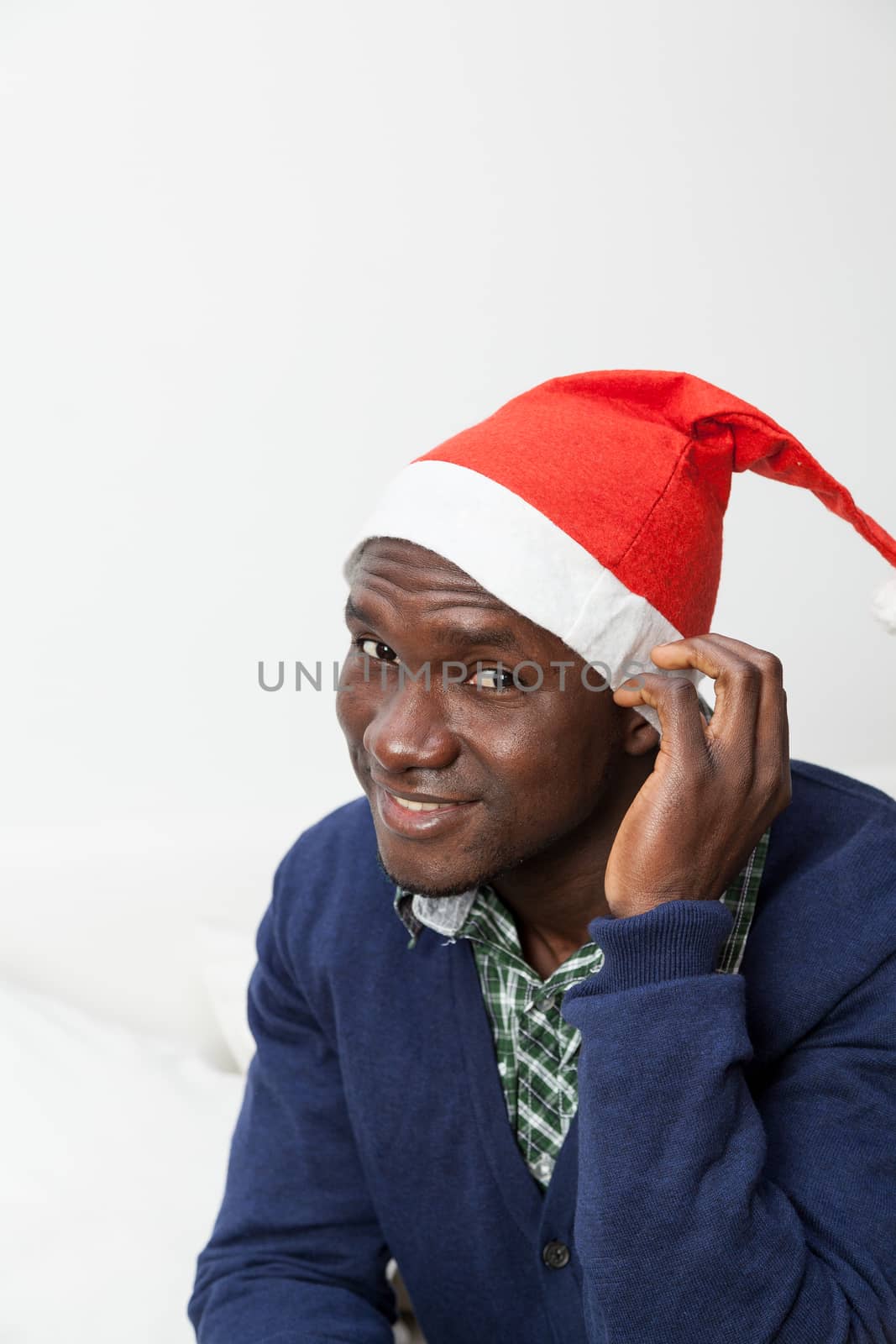 30-35, adult, african, apartment, at, attractive, black, camera, casual, christmas, cute, festive, festivity, front, happy, hat, holidays, home, homey, house, household, inside, joyful, leisure, life, living, looking, male, man, model, old, one, person, portrait, pretty, property, releases, room, sit, sitting, smiling, sofa, sweater, time, vertical, years