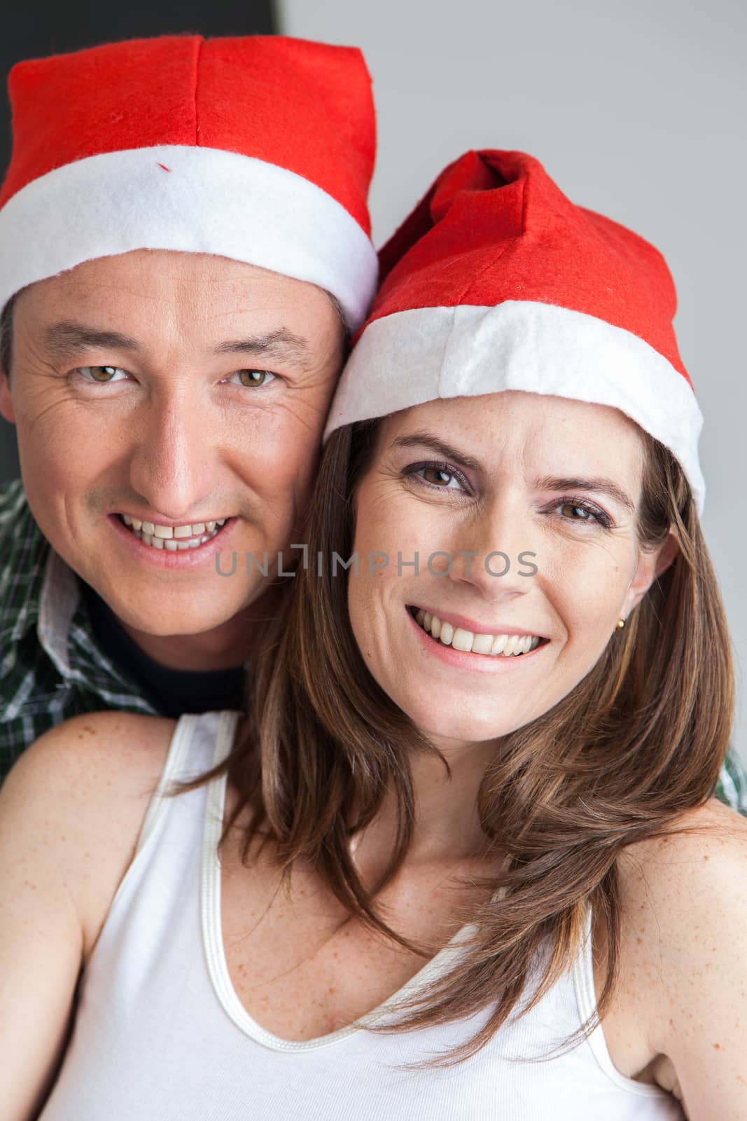 35-40, adult, affection, at, baubles, camera, caucasian, celebrating, cheerful, christmas, couple, domestic, feelings, festive, festivity, happy, hat, holding, home, house, household, joyful, life, lifestyle, living, looking, love, lover, merry, model, old, people, property, red, relationship, release, romance, romantic, smile, smiling, together, two, vertical, white, years
