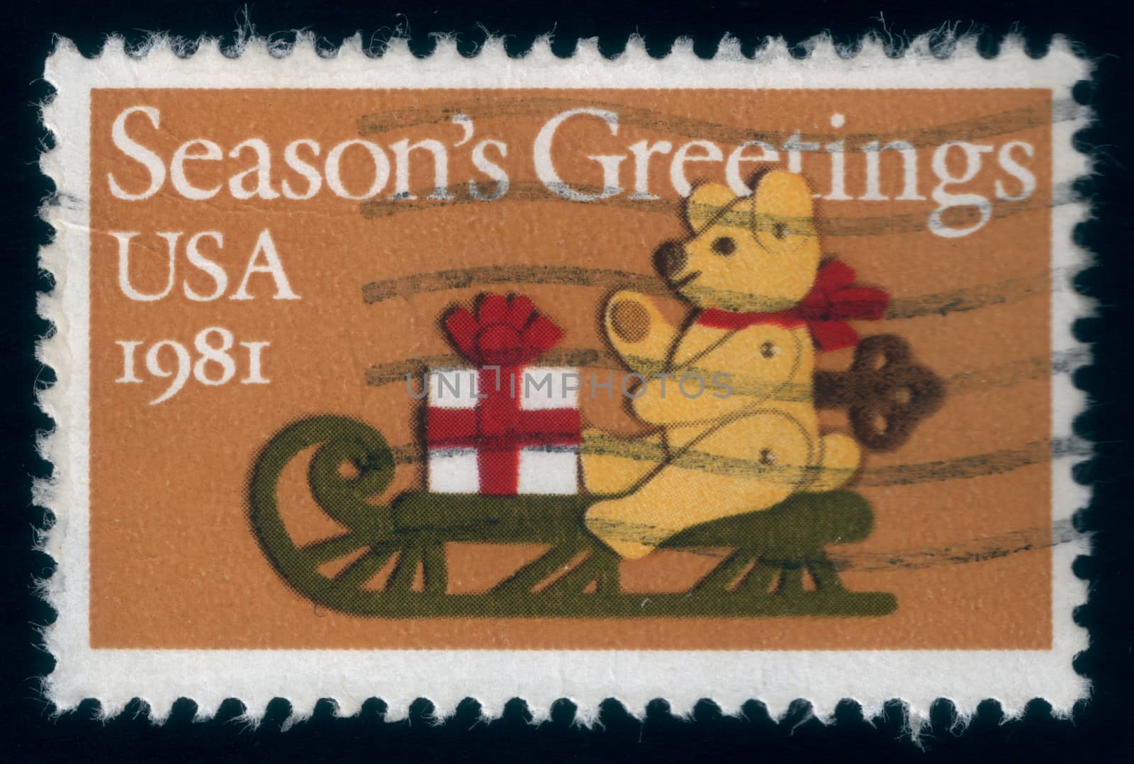 Bear greets from a sledge and brings a Christmas present. Christmas postage stamp 1981, uploaded in 2014
