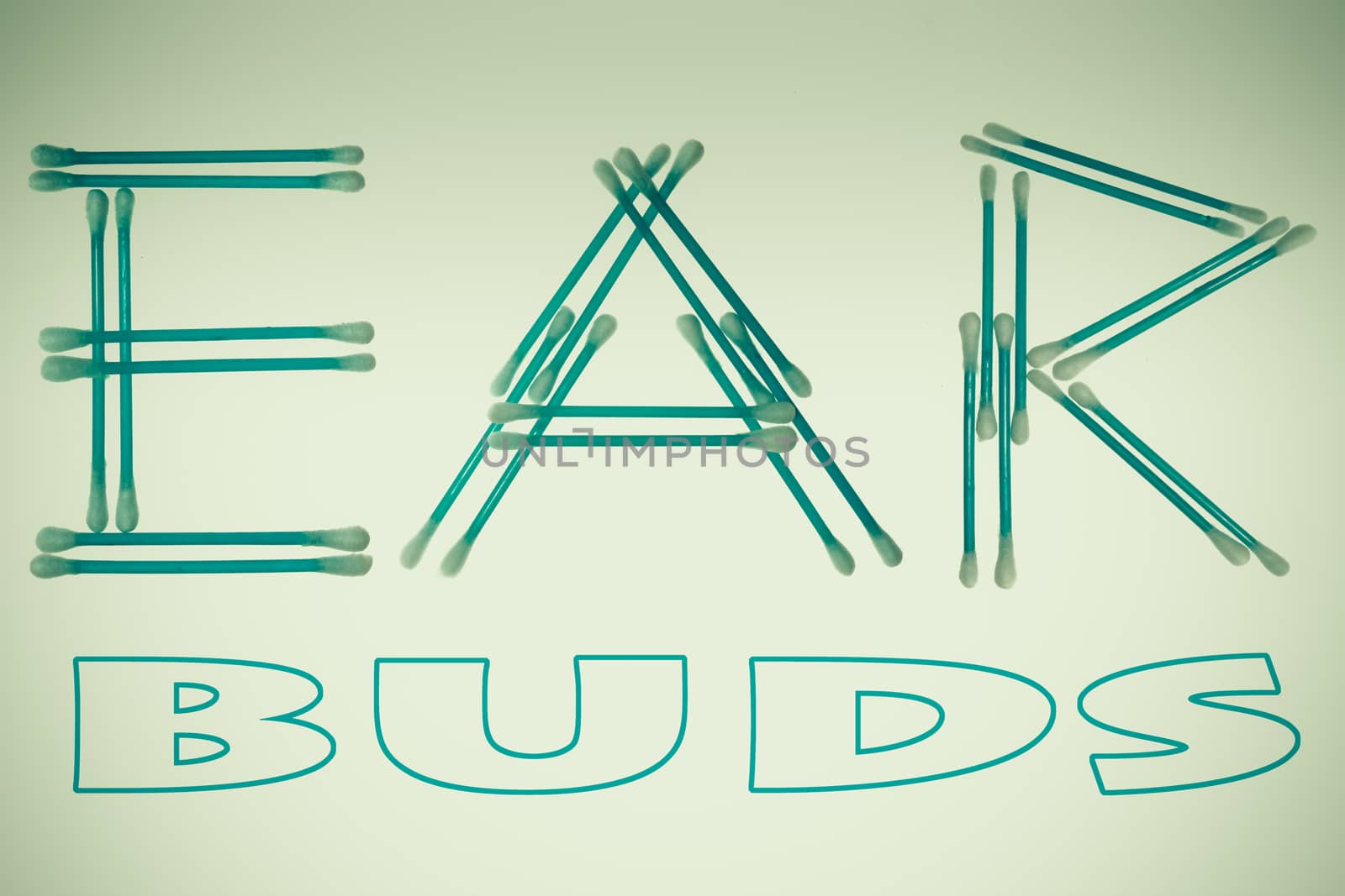 word 'Ear' written using cotton ear cleaning buds. Isolated on black