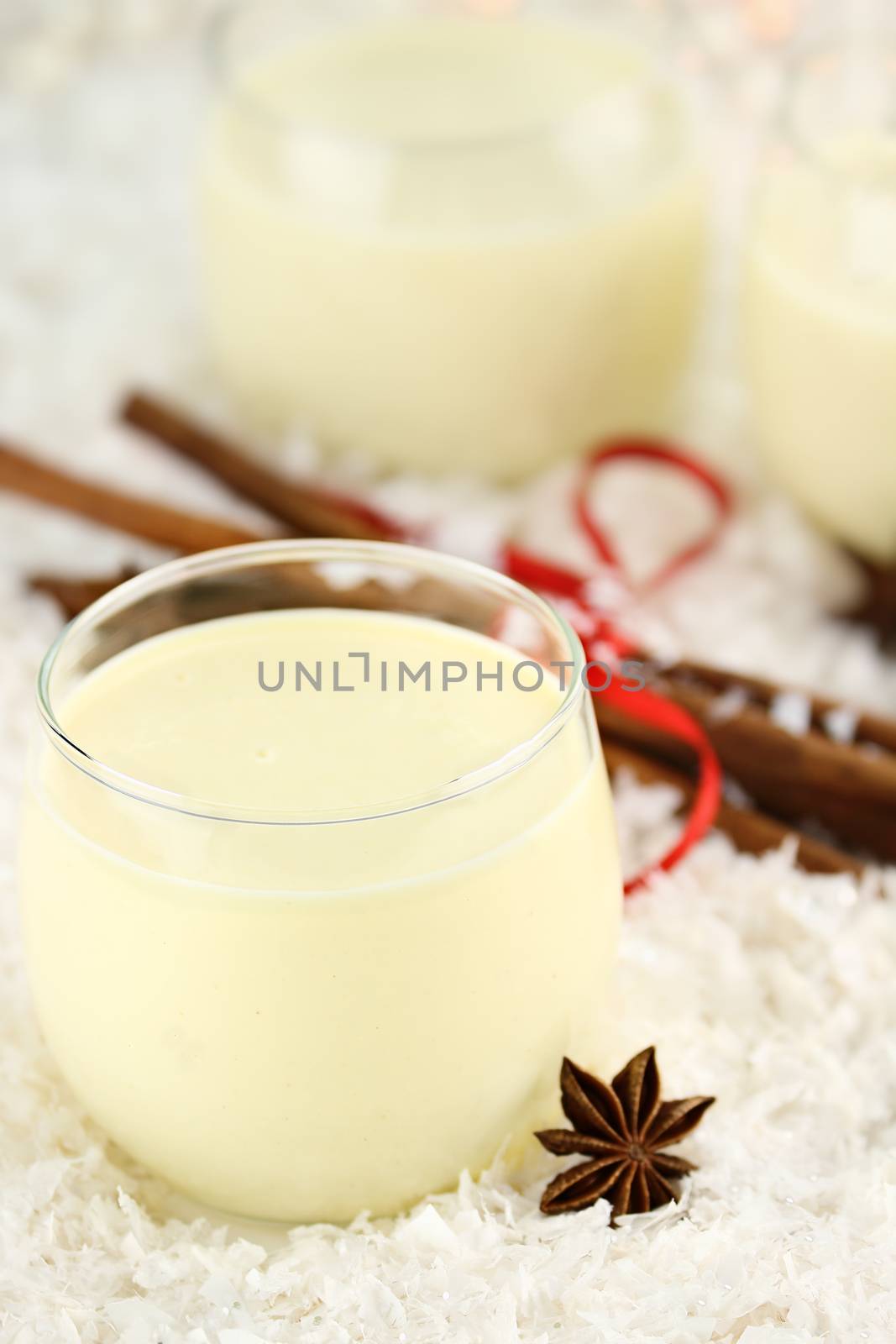 Fresh eggnog with cinnamon sticks and star of anise ready for the Christmas season. Extreme shallow depth of field.