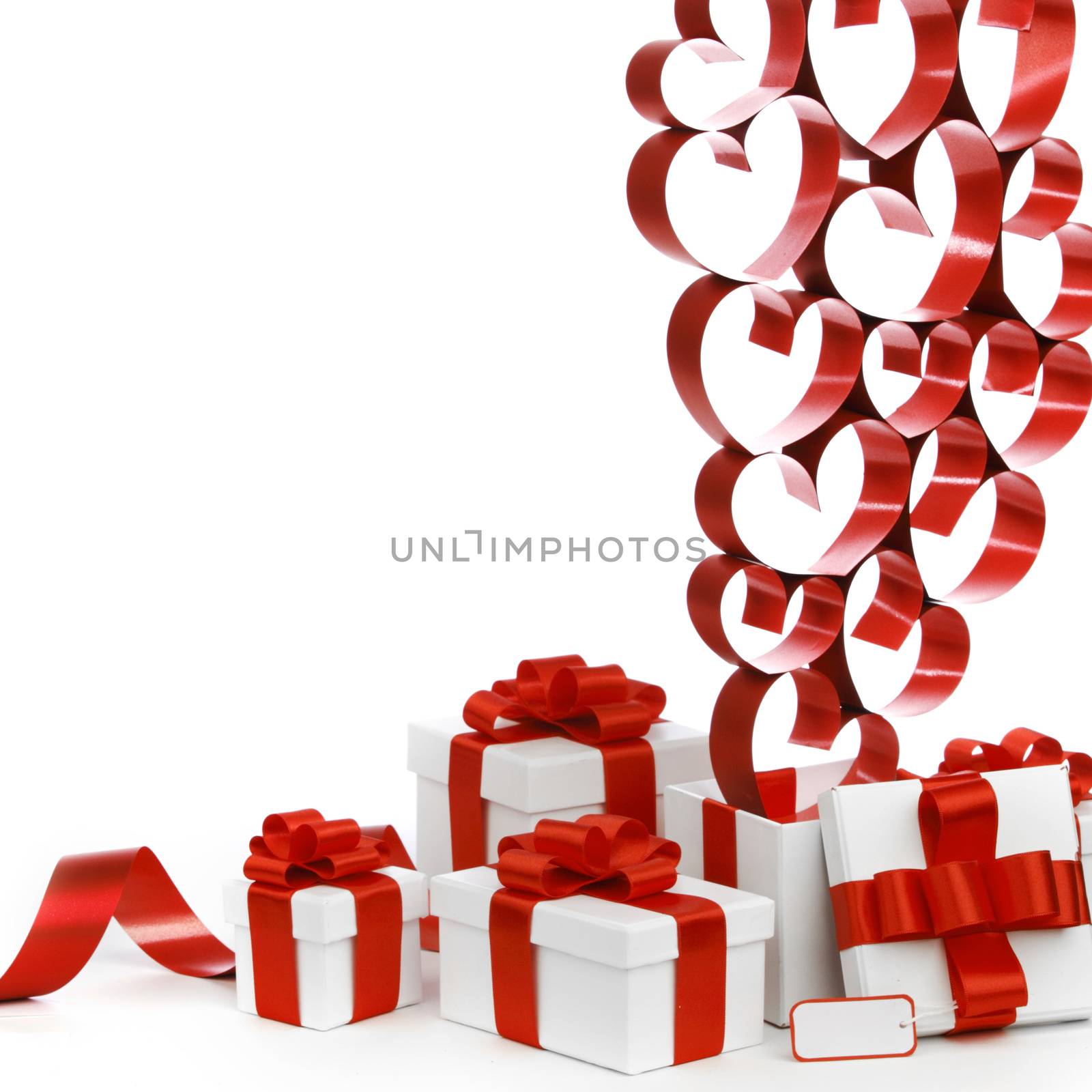 White boxes with red ribbons and decorative hearts isolated on white background