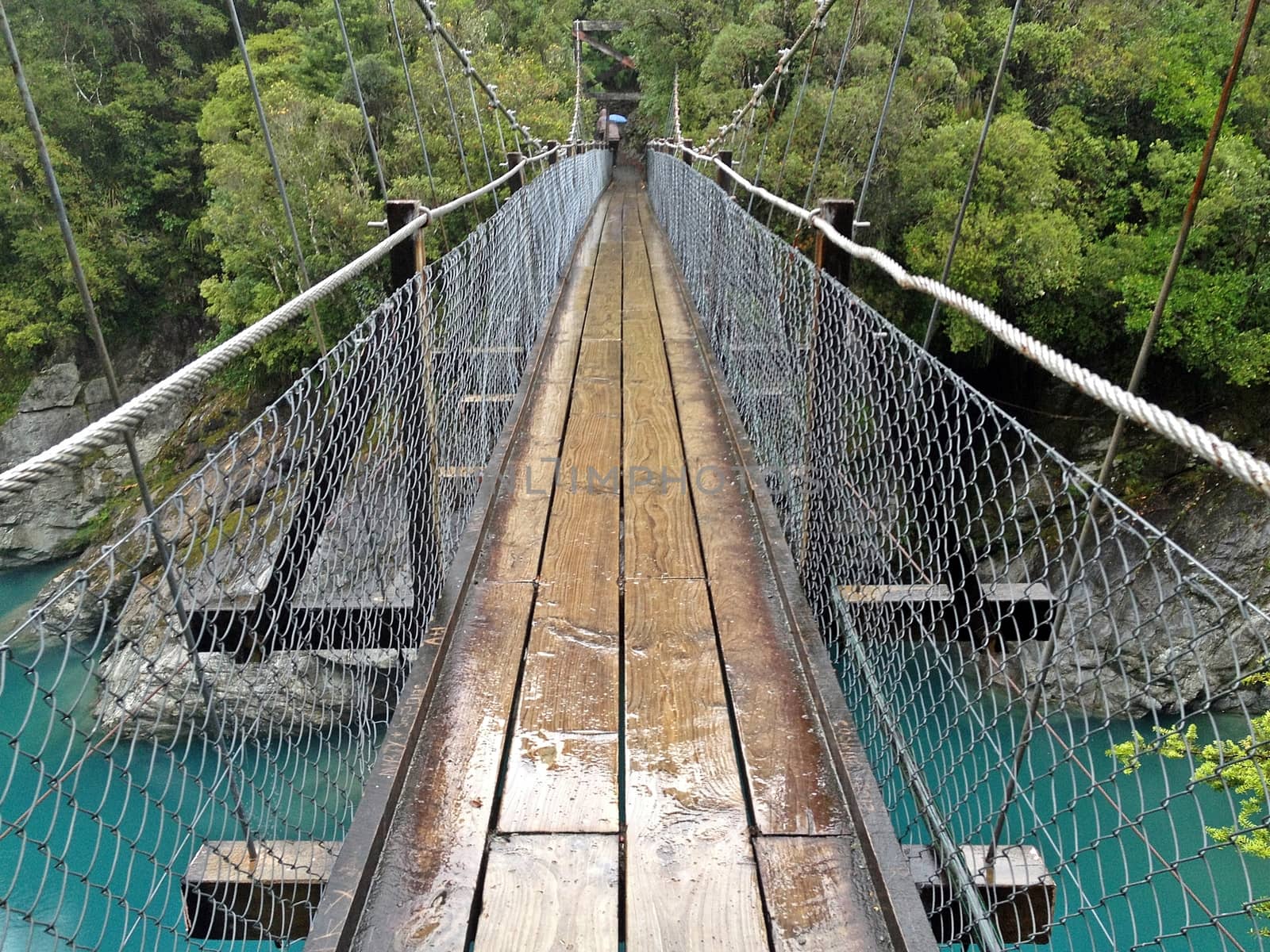 A bridge to across a light blue river in Hokitika George, South New Zealand,