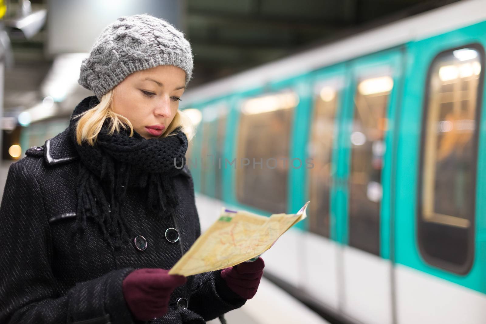 Lady waiting on subway station platform. by kasto