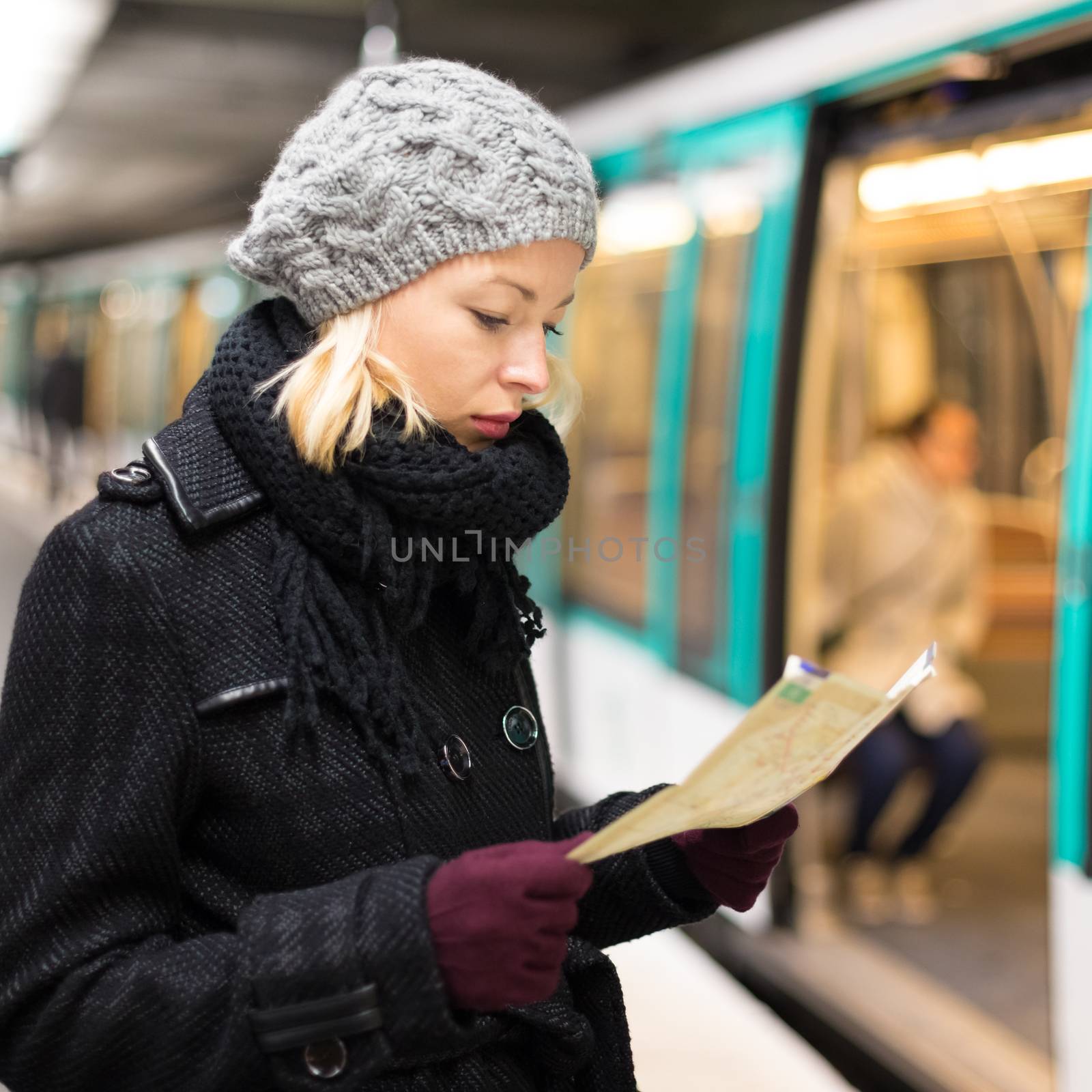 Lady waiting on subway station platform. by kasto