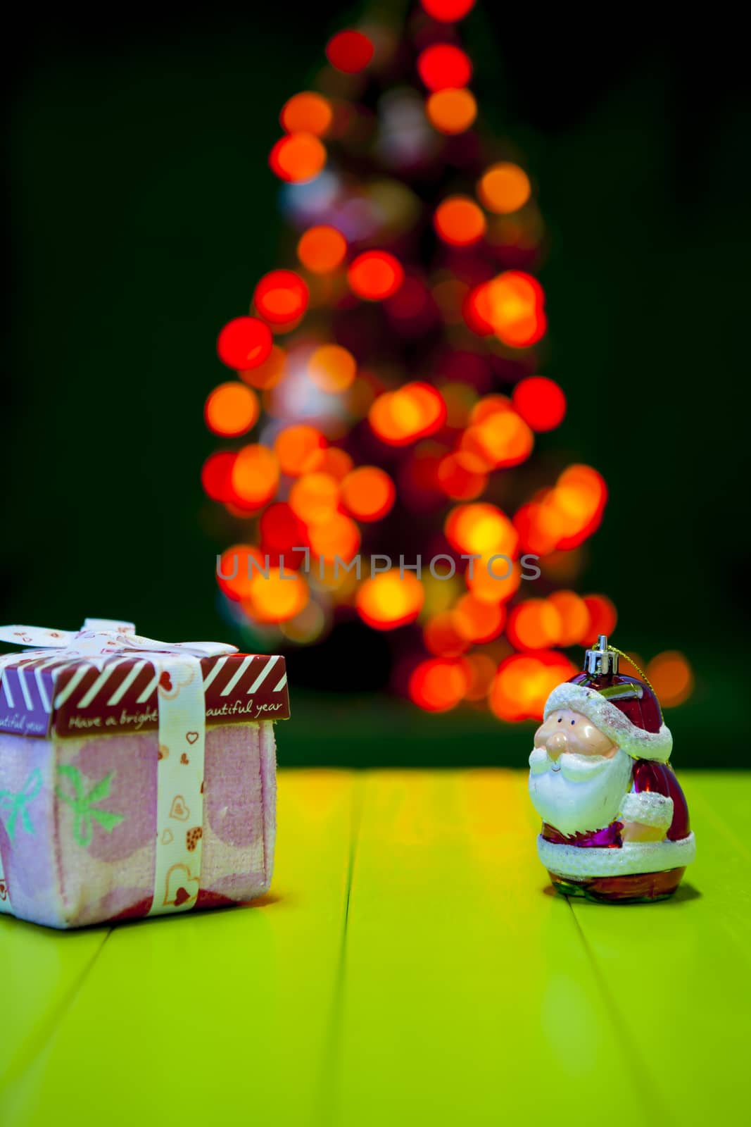 Christmas gift and santa with blurred light on background