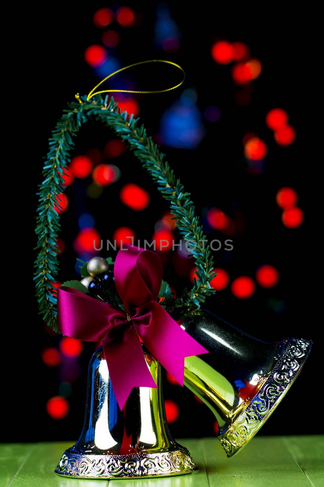 Christmas bell and red blured light on background