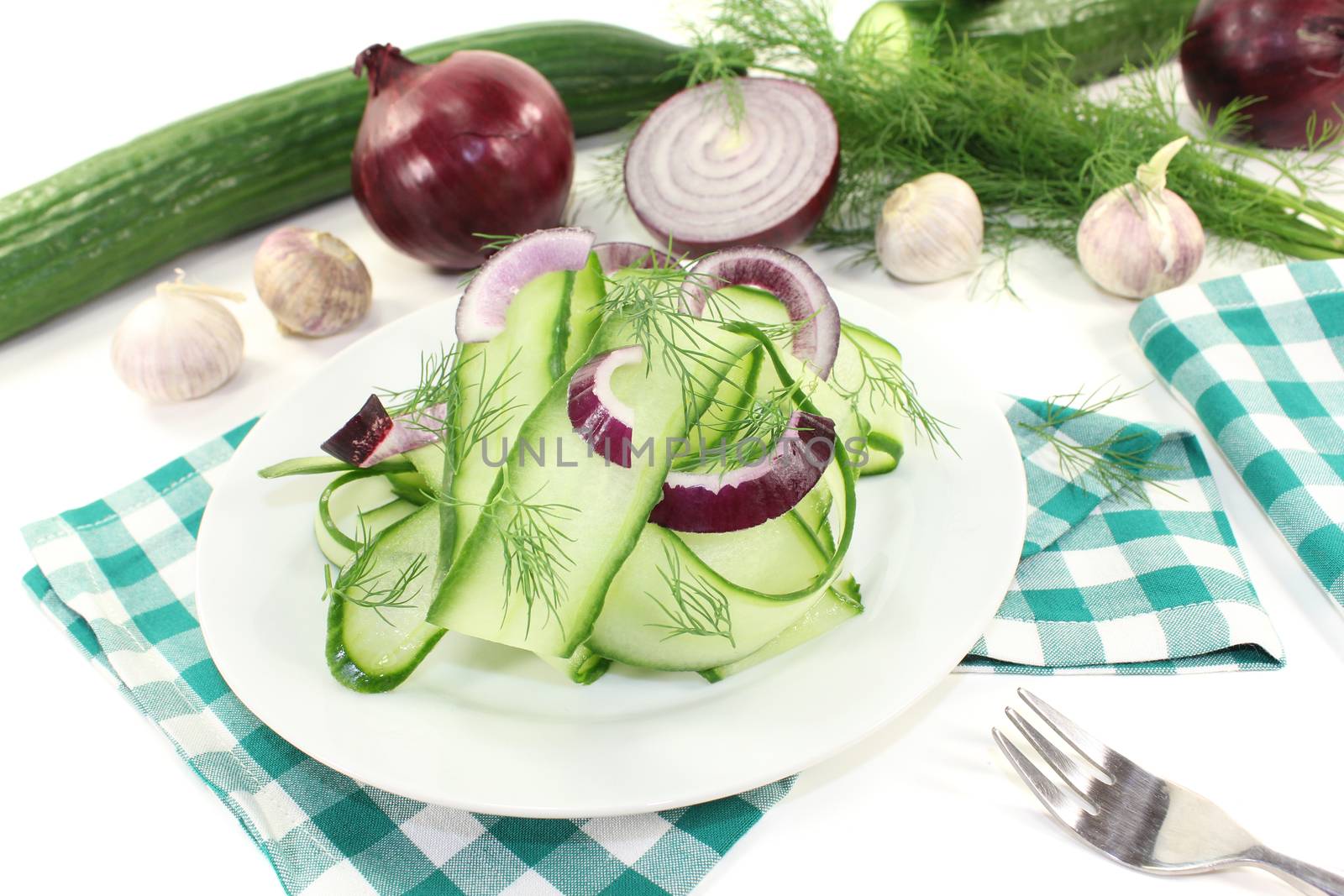 Cucumber salad with onions and dill on a plate