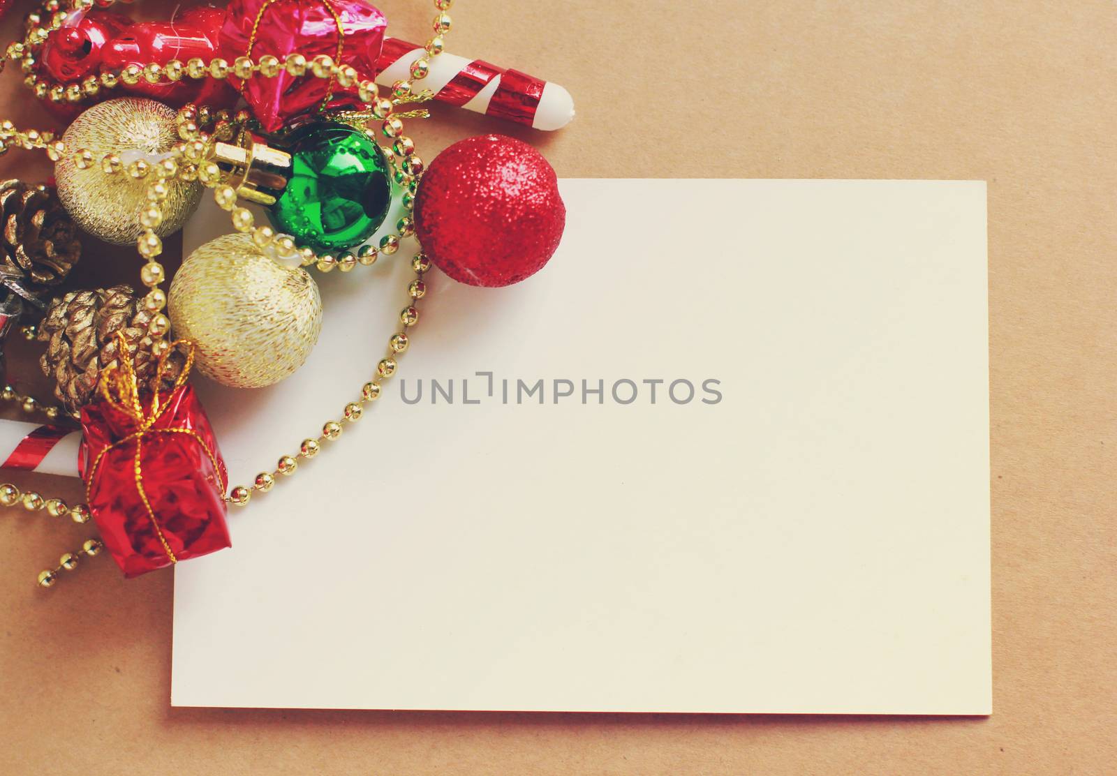 Christmas holiday background with blank greeting card and Christmas decorations, retro filter effect 