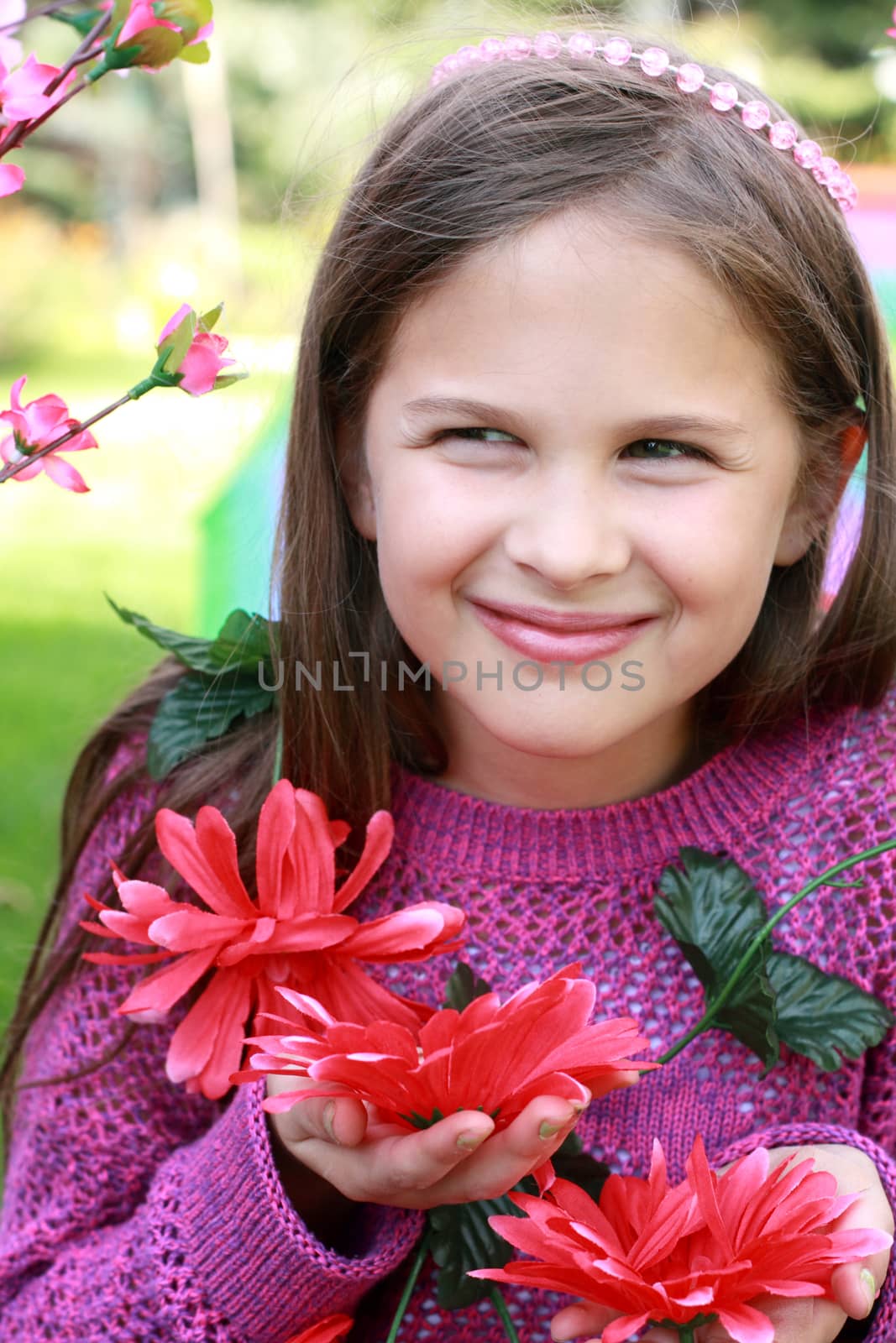 Portrait of lovely smiling girl holding flowers