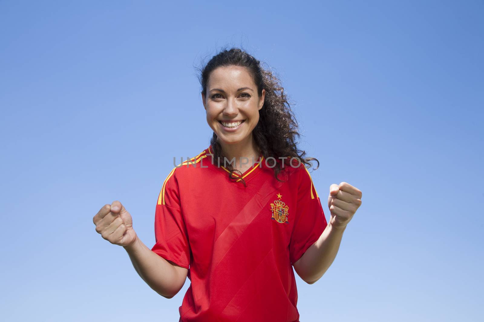 woman with spanish soccer team shirt cheering happy