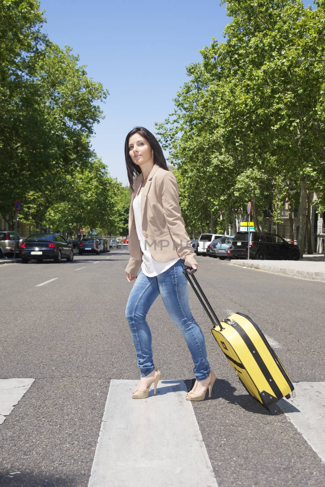 woman pulling suitcase at street in Madrid city Spain
