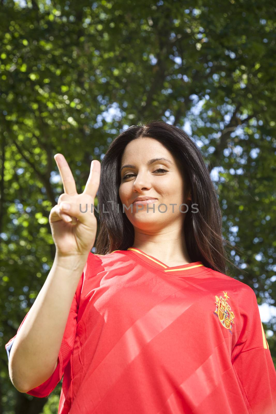 woman with spanish football team shirt cheering happy
