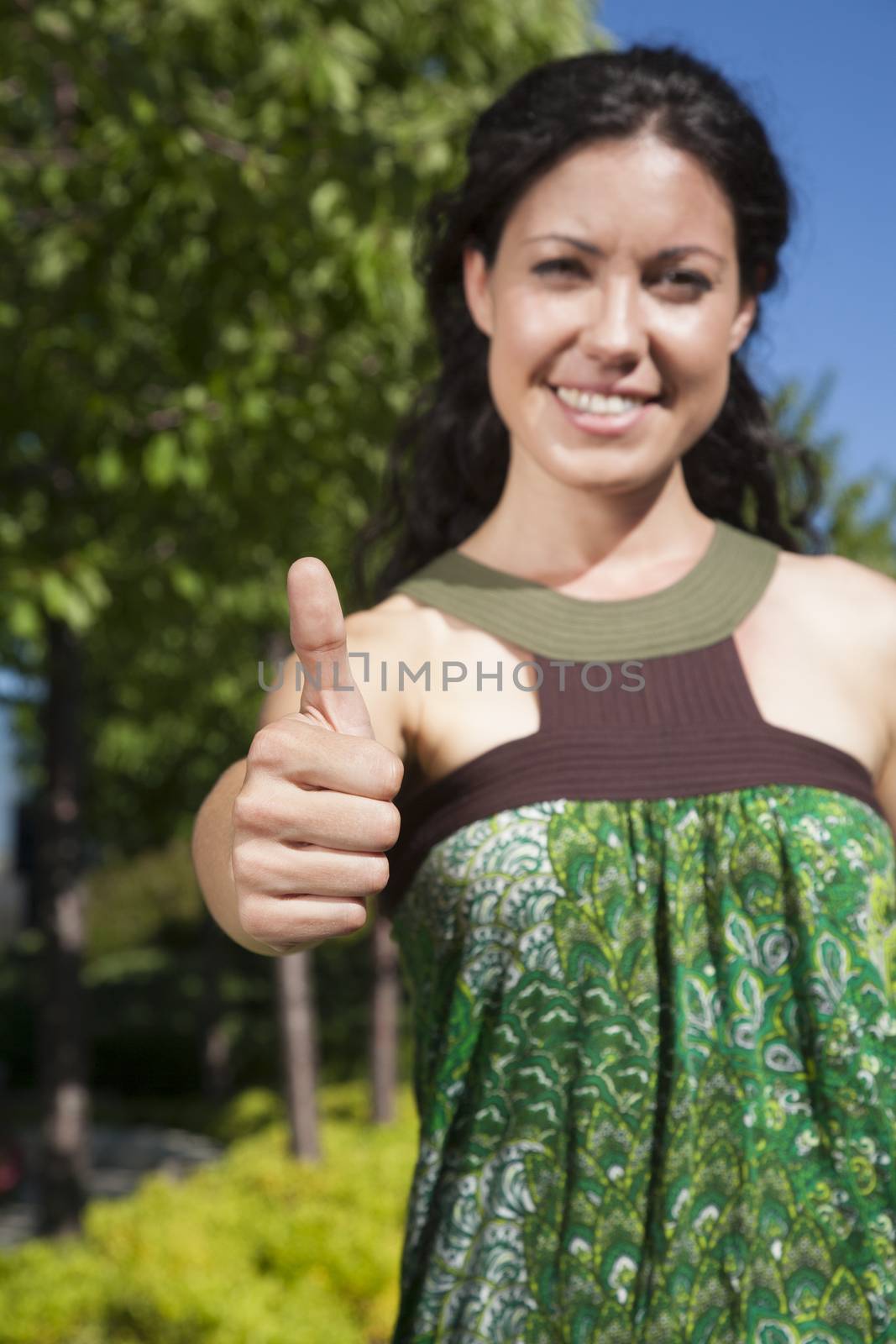 woman with thumb up in exterior background