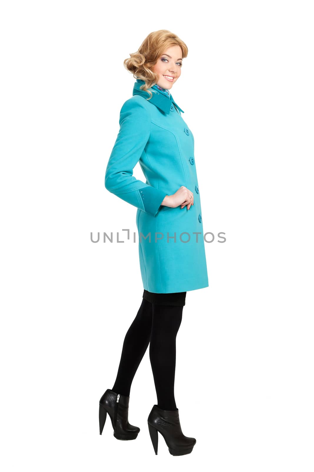 The girl in a turquoise autumn coat on a white background