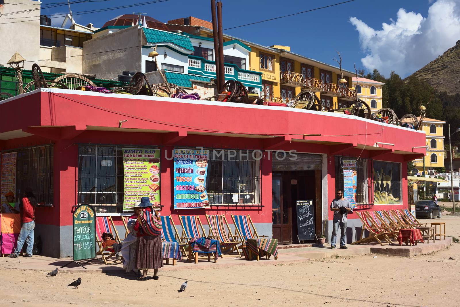 COPACABANA, BOLIVIA - OCTOBER 19, 2014: Unidentified people standing in front of the resto bar Flor de Mi Tierra on the corner of the avenues 6 de Agosto and Costanera along the shore of Lake Titicaca in the small tourist town on October 19, 2014 in Copacabana, Bolivia