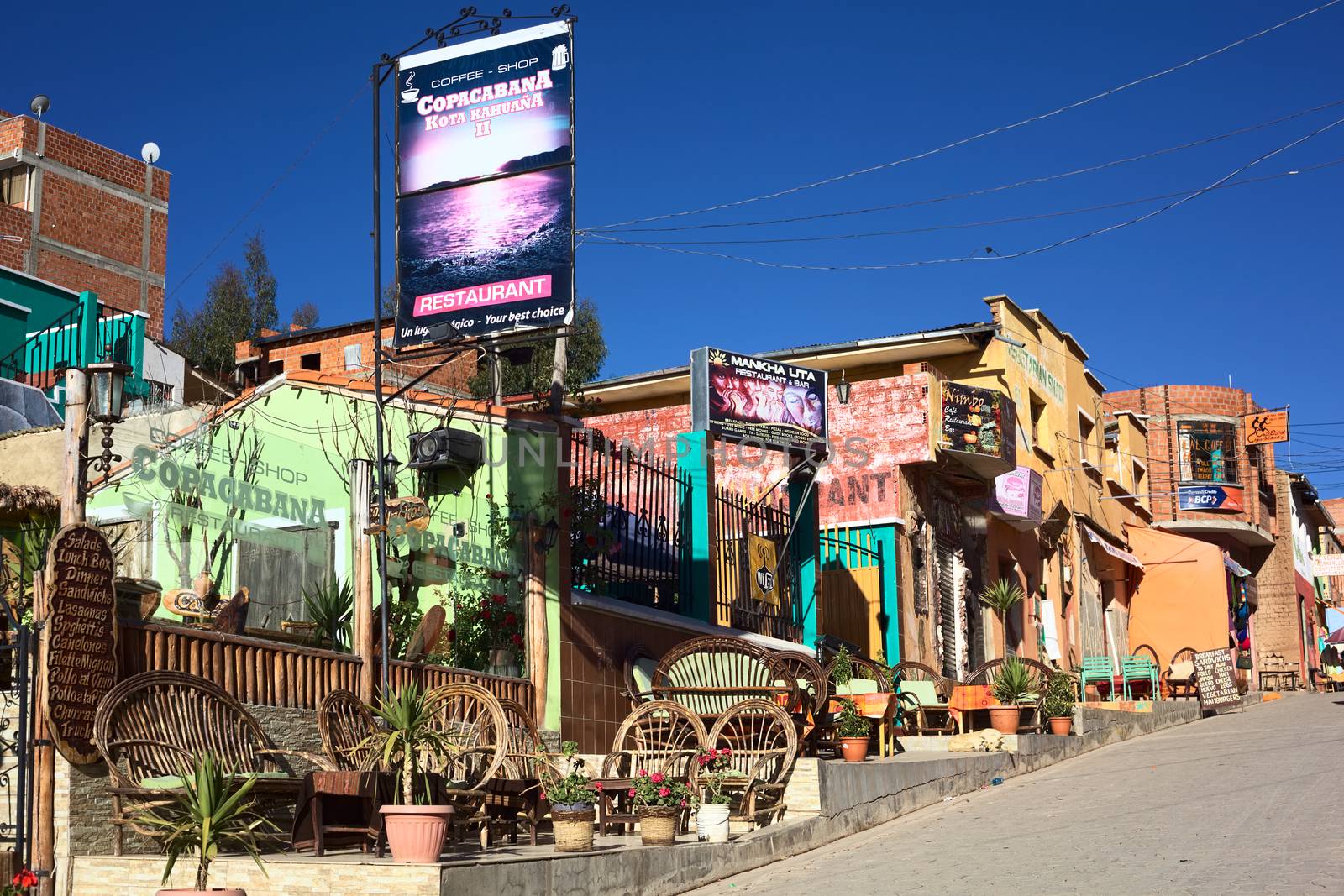COPACABANA, BOLIVIA - OCTOBER 28, 2014: Restaurants on the principal tourist street of 6 de Agosto avenue in the center of the small tourist town on October 28, 2014 in Copacabana, Bolivia 
