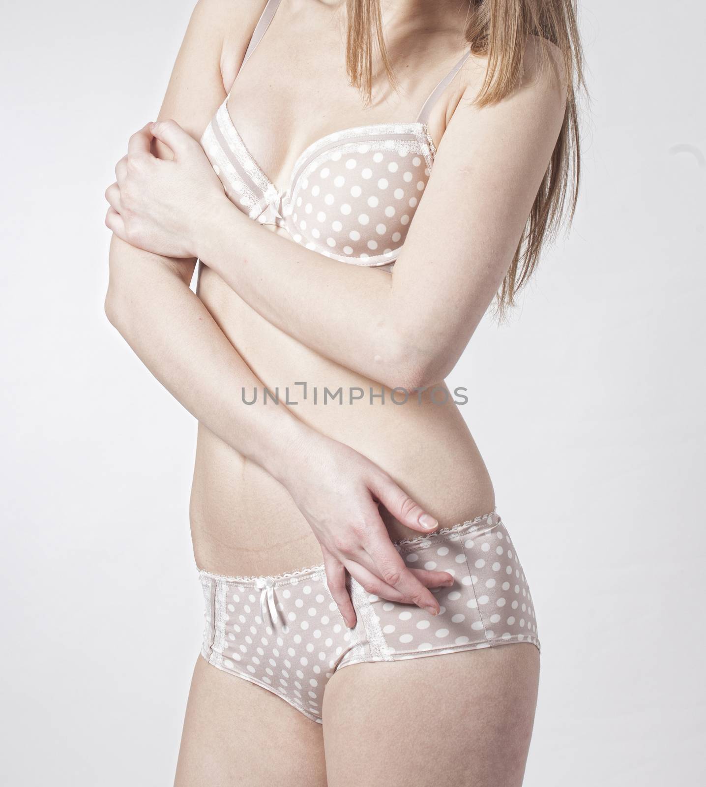 attractive woman dressed bra and panties in studio by xtate