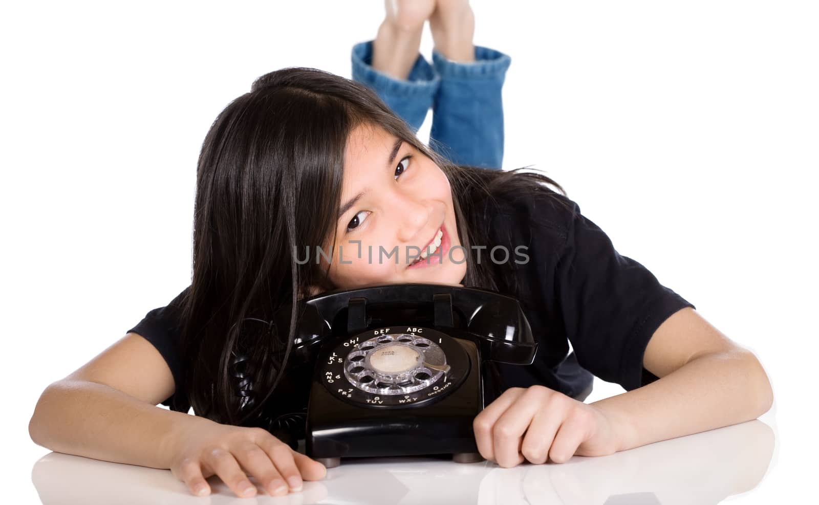 Young girl lying by old phone by jarenwicklund