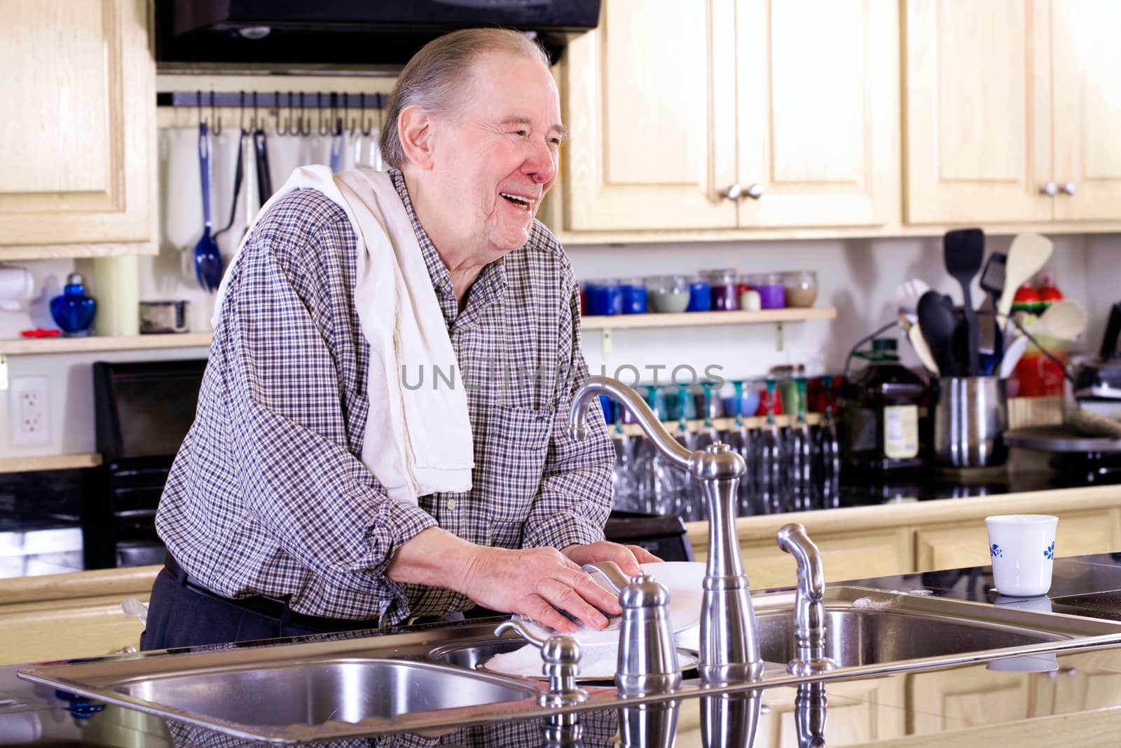 Elderly man washing dishes by jarenwicklund