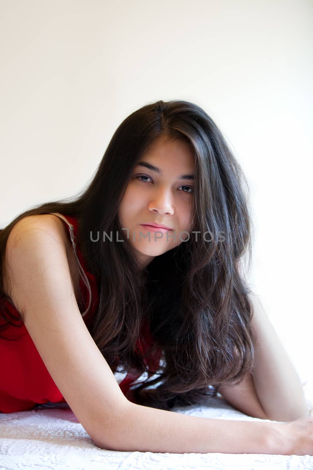 Beautiful biracial teen girl lying down, relaxing by jarenwicklund