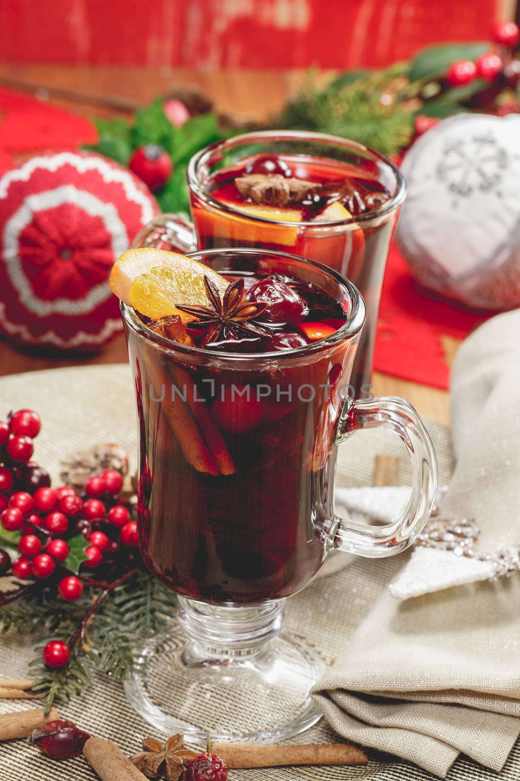 Delicious mulled wine with apple cider, fruits and spices. A macro photograph with shallow depth of field. Done with vintage retro filter.