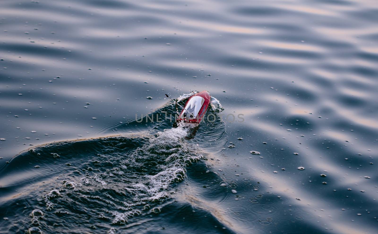 Remote control boat in the blue lake
