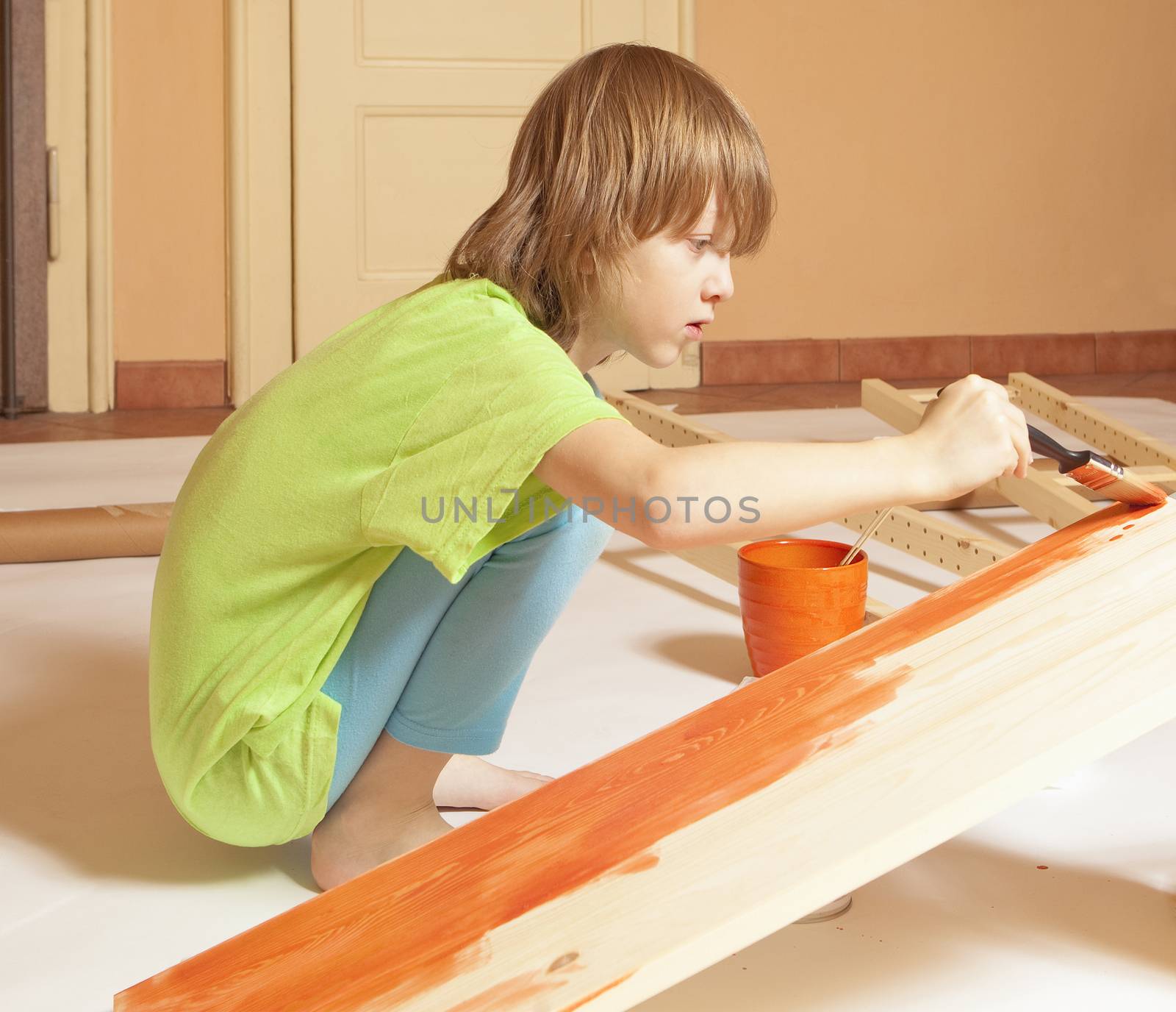 Boy with Blond Hair Painting a Board by courtyardpix