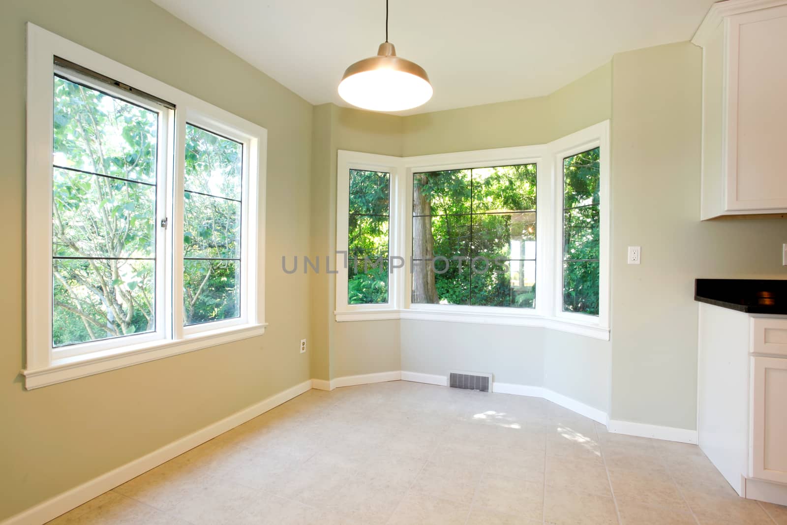 Bright empty dining room interior with tile floor and round corner