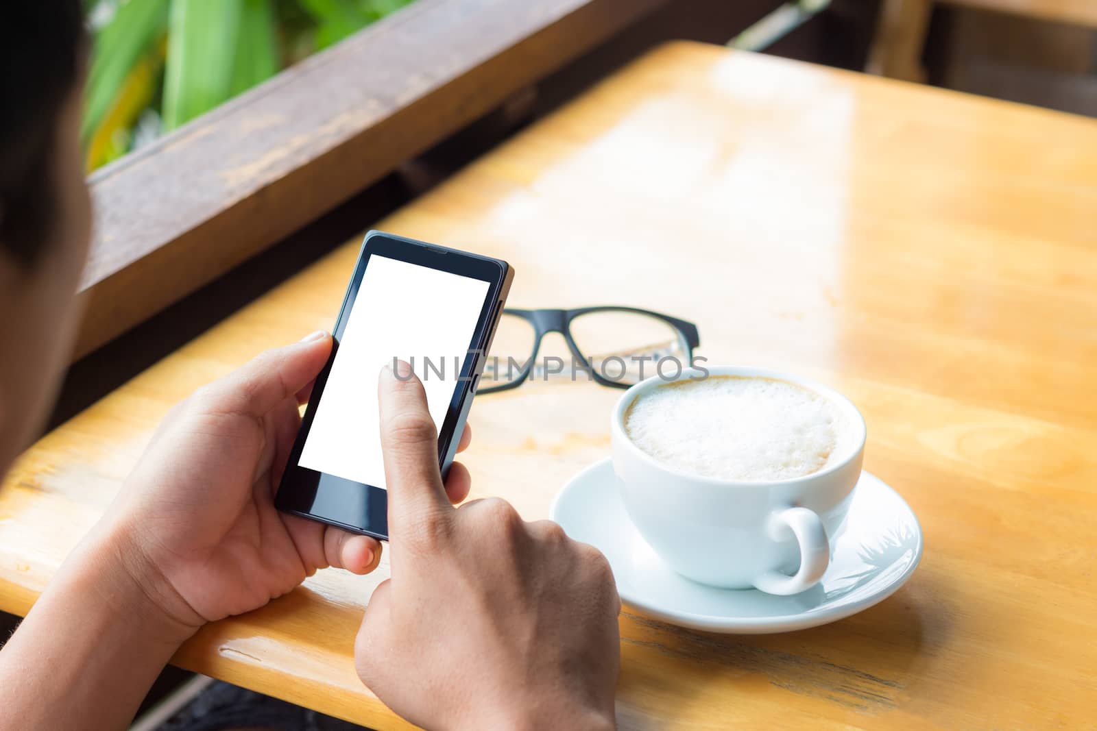 man use smart phone in coffee shop by blackzheep