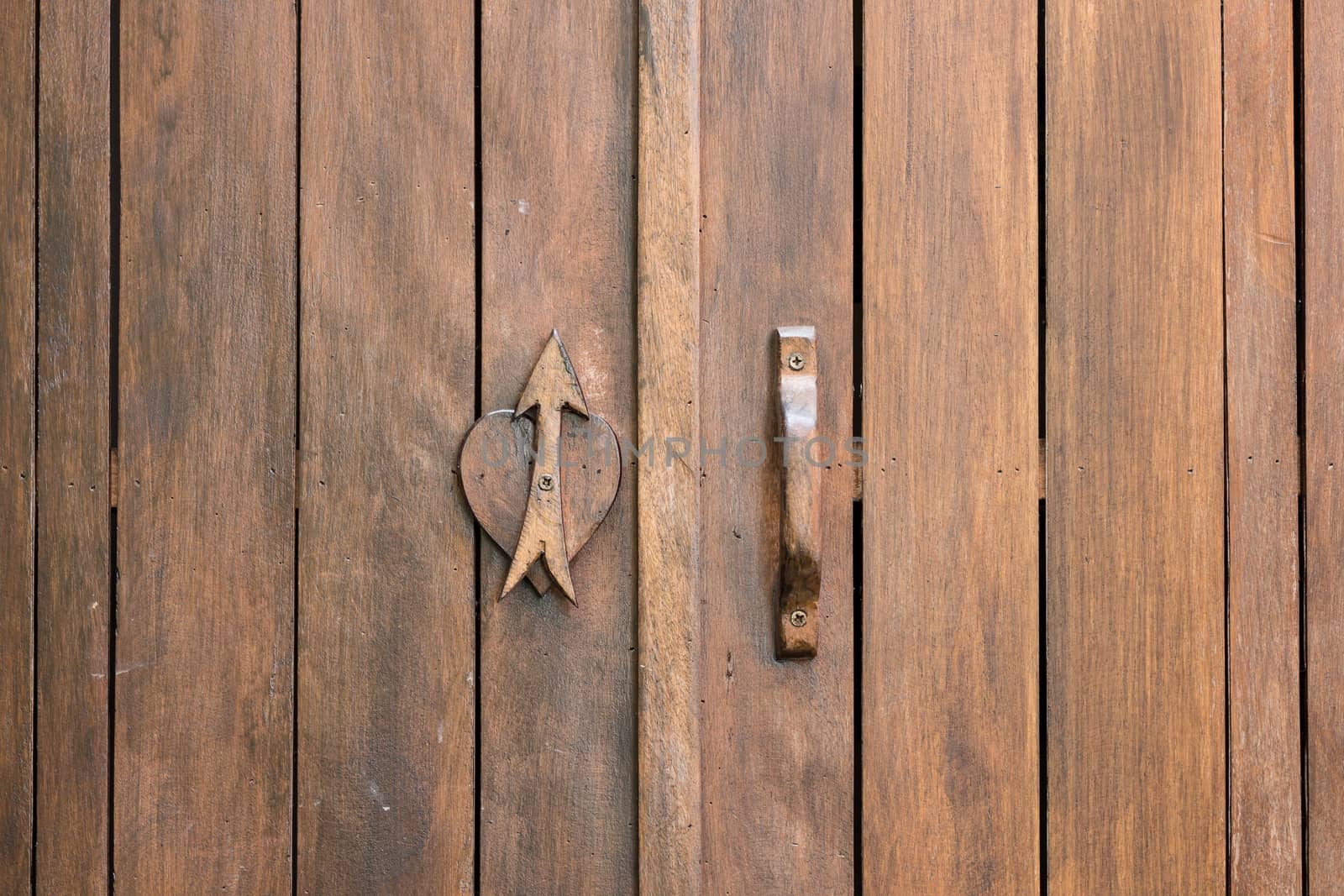love symbol on wood door background by blackzheep