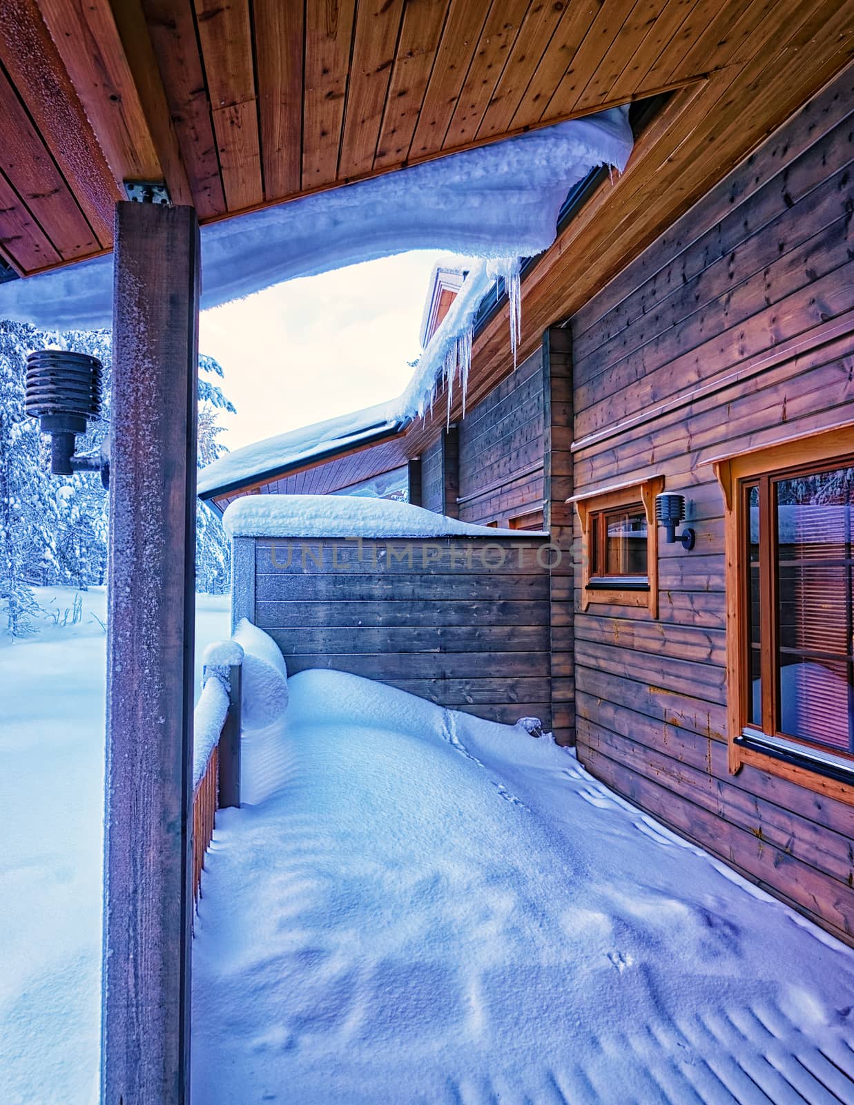 Terrace under snow in forest cottage
