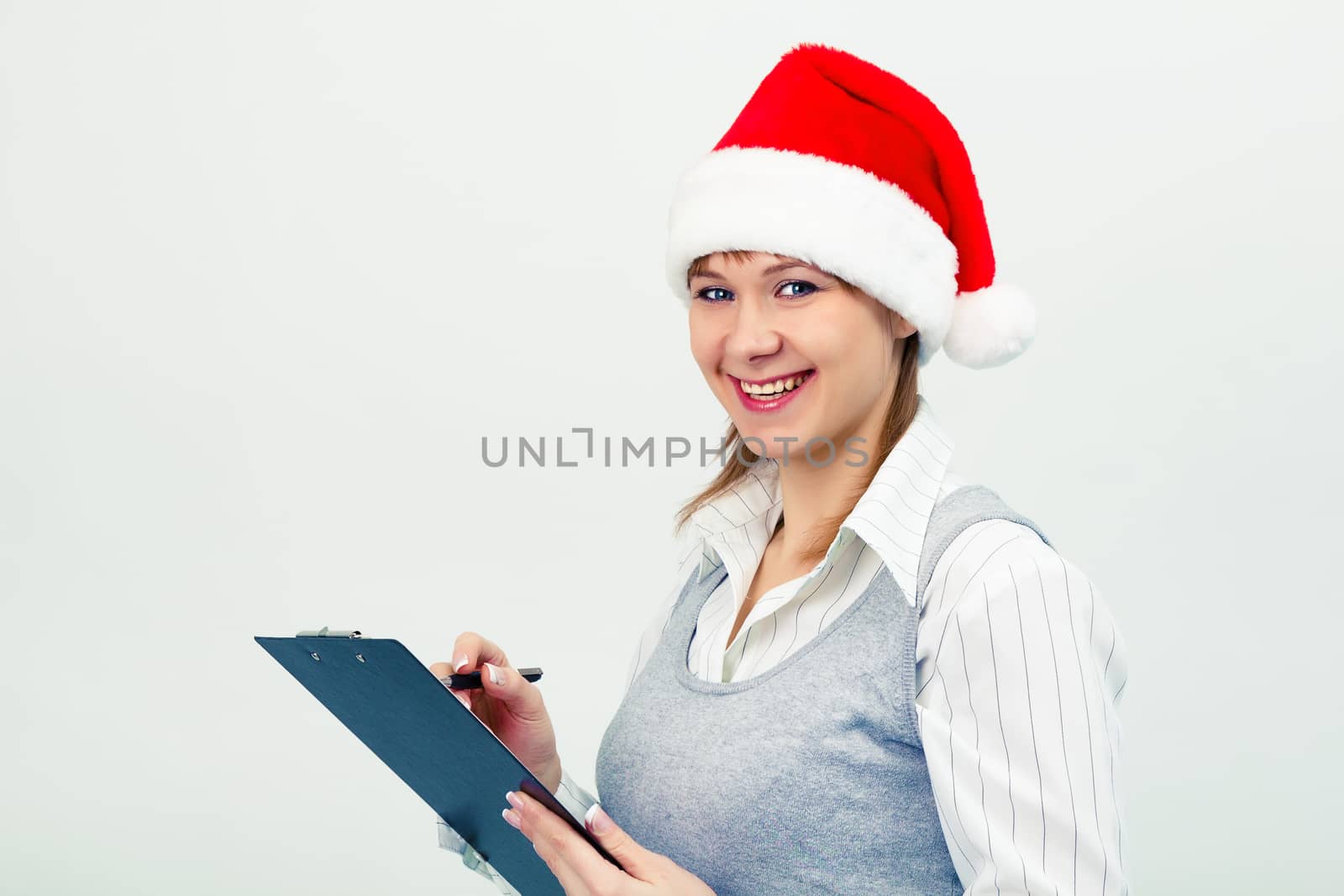 happy girl in santa hat with a notebook by pzRomashka