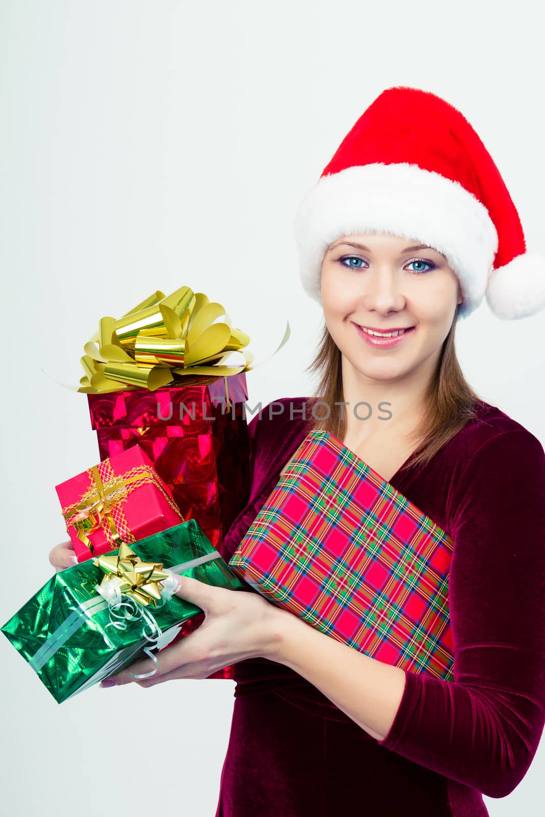 happy girl in santa hat with gift boxes by pzRomashka