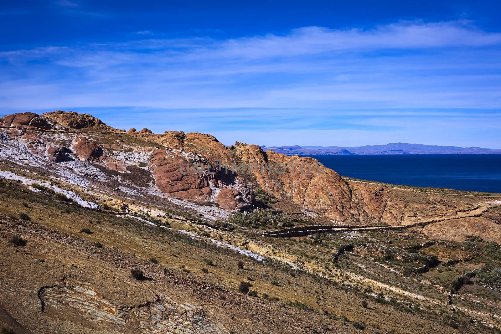 Colorful rocky hillside with path leading to the archeological site on the northern part of the Isla del Sol (Island of the Sun) in Lake Titicaca, which is a popular travel destination in Bolivia